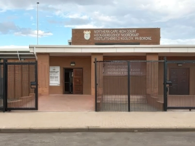 High-security fencing and access control system installed at a government facility, featuring anti-climb mesh panels and secure pedestrian gates.
